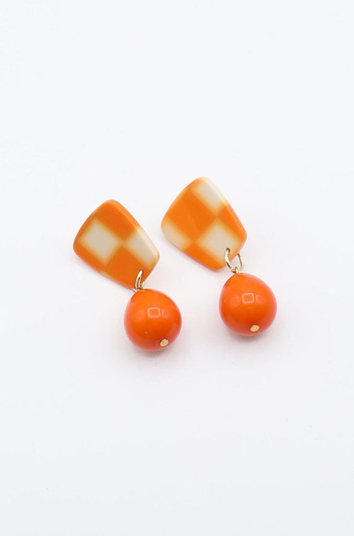 Checkerboard Earrings With Dangling Solid Orange Teardrop Accent Bead