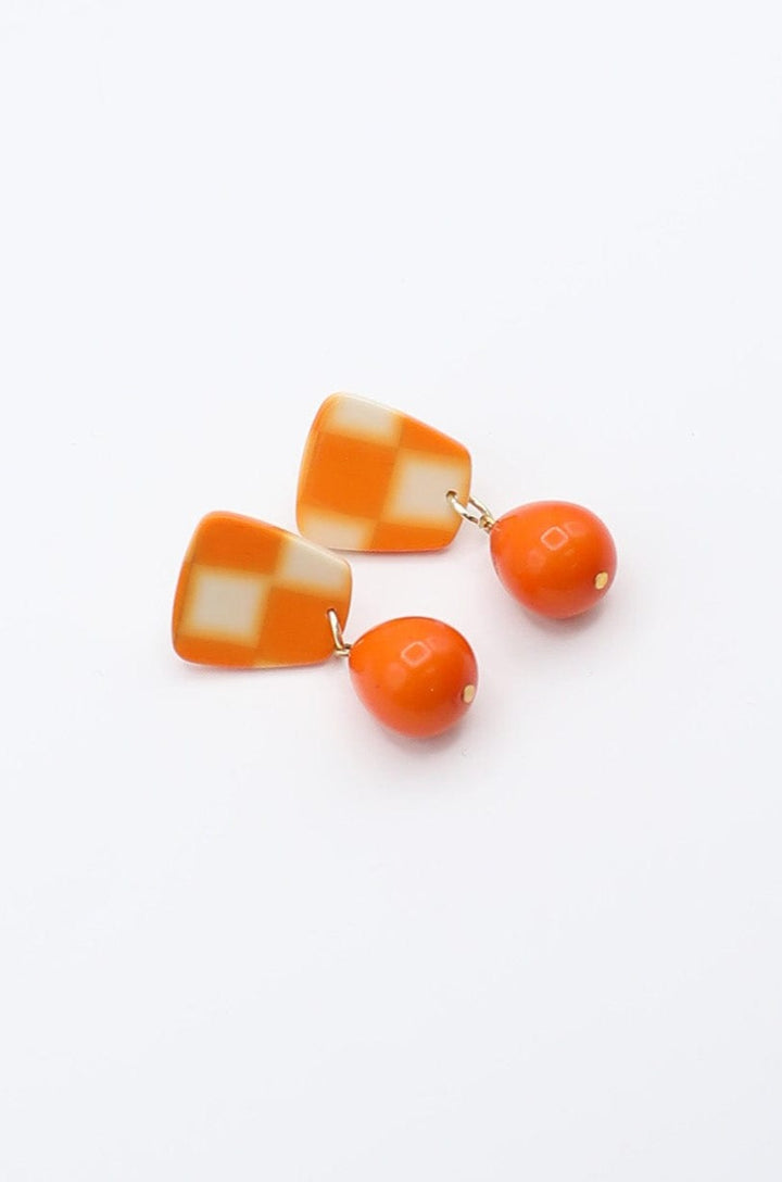 Checkerboard Earrings With Dangling Solid Orange Teardrop Accent Bead